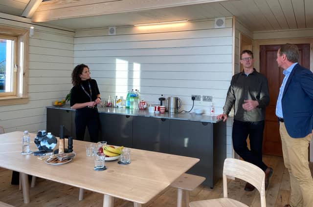 Mairi Gougeon MSP, the Scottish Government's Cabinet Secretary for Rural Affairs & Islands, Peter Smith of Roderick James Architects and Stuart Goodall in the Zero Carbon House.