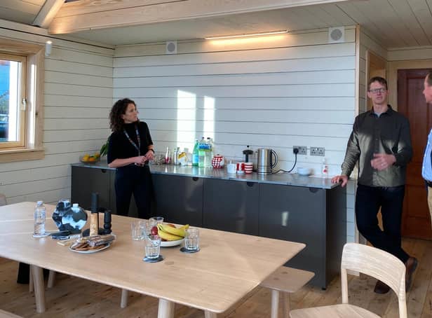 Mairi Gougeon MSP, the Scottish Government's Cabinet Secretary for Rural Affairs & Islands, Peter Smith of Roderick James Architects and Stuart Goodall in the Zero Carbon House.