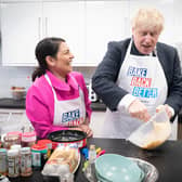 Home secretary Priti Patel looks on as Prime Minister Boris Johnson tries his hand at baking during a visit to the HideOut Youth Zone in Manchester. Picture: Stefan Rousseau-WPA Pool/Getty Images)