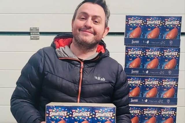 Dan Dafydd with some of the over ordered Easter eggs at Sinclair General Stores. Picture: SWNS