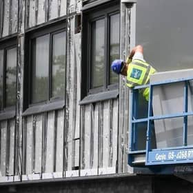 Workers remove cladding for testing from a tower block in the wake of the Grenfell Tower tragedy. Picture: Christopher Furlong/Getty Images