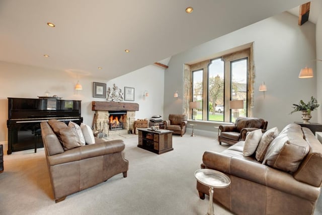 The formal lounge is a superb and spacious reception room with a vaulted ceiling and an open fire.