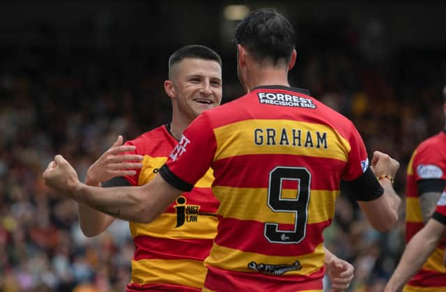 Partick's Aidan Fitzpatrick celebrates his opener with Brian Graham, who went on to score Thistle's second in the 2-0 win over Ross County. (Photo by Craig Foy / SNS Group)