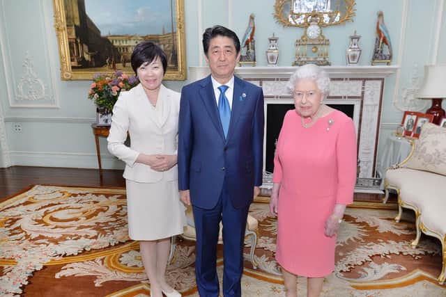 Shinzo Abe and wife Akie with the Queen at Buckingham Palace in 2016 (Picture: PA)