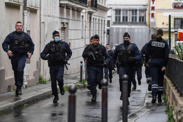 French police officers rush to the scene after people were injured near the former offices of the French satirical magazine Charlie Hebdo following an alleged attack by a man wielding a knife in the capital Paris. (Photo by Alain JOCARD / AFP) (Photo by ALAIN JOCARD/AFP via Getty Images)