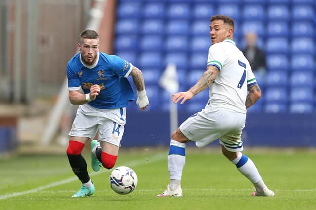 Ryan Kent of Rangers looks to get past Tranmere Rovers' goalscorer Kieron Morris during the pre-seaon meeting between the two sides at Prenton Park
