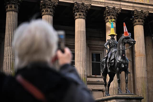 The Duke of Wellington Statue wears a traffic cone with a knitted cover in the colours of the Ukraine flag. Picture: Jeff J Mitchell/Getty Images