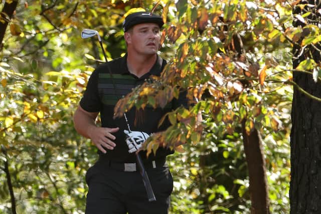 Deep in the trees, Bryson DeChambeau watches his second shot on the 11th hole during the first round of the Masters at Augusta National. Picture: Jamie Squire/Getty Images