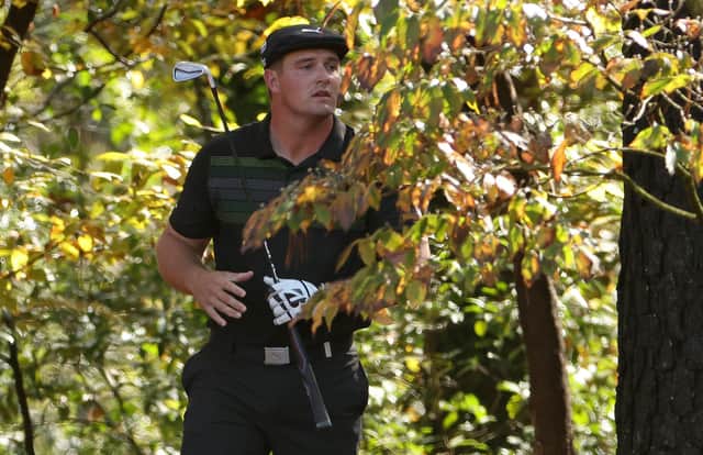 Deep in the trees, Bryson DeChambeau watches his second shot on the 11th hole during the first round of the Masters at Augusta National. Picture: Jamie Squire/Getty Images
