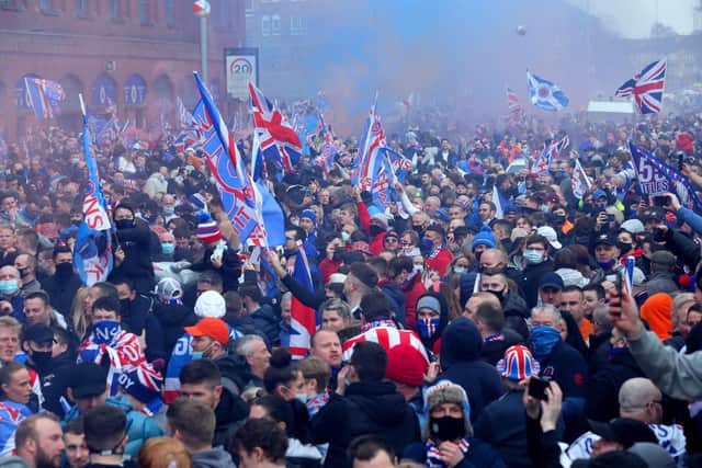 Rangers fans celebrate outside of the Ibrox Stadium after Rangers win the Scottish Premiership title. Picture date: Sunday March 7, 2021. PA Photo. See PA story SOCCER Rangers. Photo credit : Robert Perry/PA Wire.