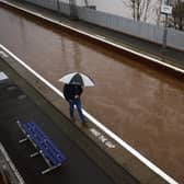 A member of the public is seen on the platform of Bowling station which is shut by flooding on December 27, 2023 in Bowling. Picture: Getty