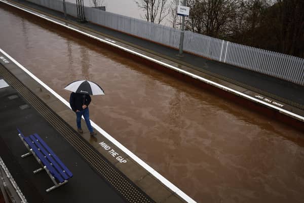 A member of the public is seen on the platform of Bowling station which is shut by flooding on December 27, 2023 in Bowling. Picture: Getty