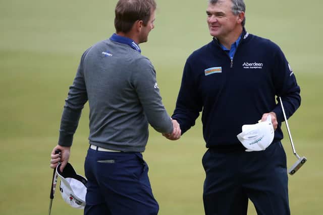 Paul Lawrie, right, shakes hands with Marc Warren on the 18th green after the two Scots played together in the third round of the 144th Open at St Andrews in 2015. Picture: Streeter Lecka/Getty Images.