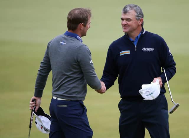 Paul Lawrie, right, shakes hands with Marc Warren on the 18th green after the two Scots played together in the third round of the 144th Open at St Andrews in 2015. Picture: Streeter Lecka/Getty Images.