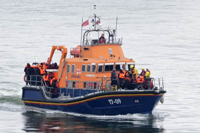 A group of people thought to be migrants are brought in to Dover. PIC: Gareth Fuller/PA Wire