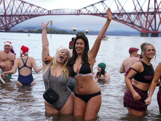 People take part in the Loony Dook New Year's Day dip in the Firth of Forth at South Queensferry