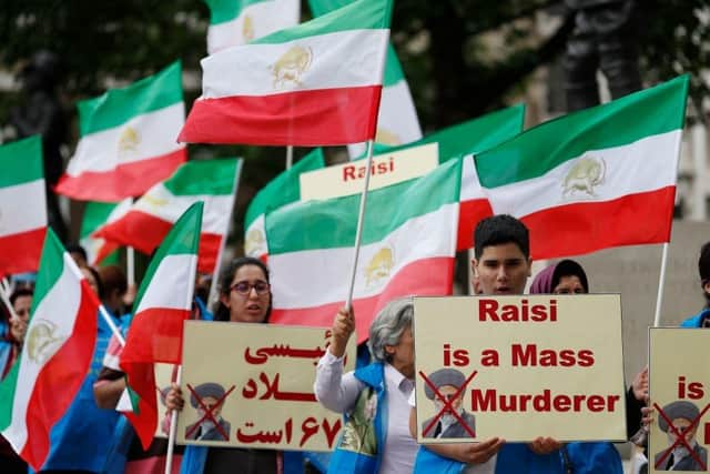 Protesters wave Iranian opposition flags and hold banners during a demonstration organised by supporters of the National Council of Resistance of Iran (NCRI) to protest against the inauguration of Iran's president Ebrahim Raisi outside Downing Street in London last year.