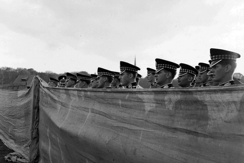 In the 1950s and 1960s the British Army regularly held displays and recruitment drives in the Meadows. This picture shows the 'Scottish Command Meet the Army' display in the East Meadows in June 1959, with Scots Guards soldiers looking over a high canvas wall.