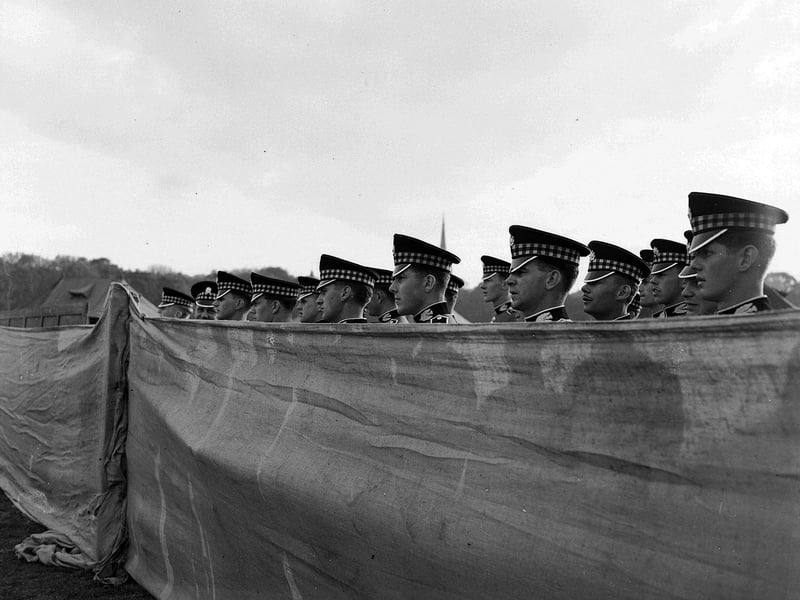 In the 1950s and 1960s the British Army regularly held displays and recruitment drives in the Meadows. This picture shows the 'Scottish Command Meet the Army' display in the East Meadows in June 1959, with Scots Guards soldiers looking over a high canvas wall.