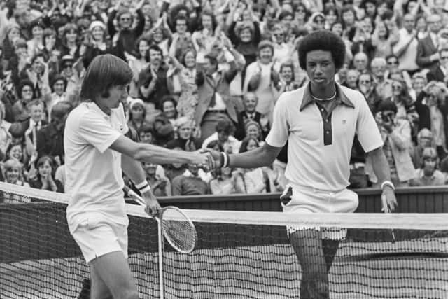 5th July 1975: American tennis players Arthur Ashe (1943 - 1993) and Jimmy Connors shaking hands after the men's singles final at the Wimbledon Lawn Tennis Championships, which was won by Ashe. (Photo by Keystone/Getty Images)