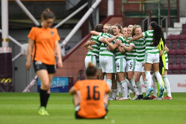 The Celtic squad celebrate winning the cup leaving the Glagsow City players dejected. (Photo by Craig Foy / SNS Group)