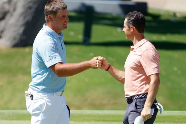 Bryson DeChambeau and Rory McIlroy bump fists during last year's Charles Schwab Challenge in Fort Worth, Texas. Picture: Tom Pennington/Getty Images.