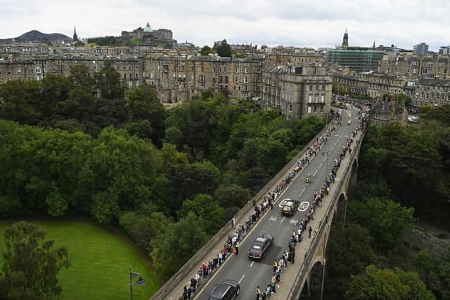 The hearse carrying the coffin of Queen Elizabeth II, draped with the Royal Standard of Scotland, passing through the outskirts of Edinburgh as it continues its journey to the Palace of Holyroodhouse from Balmoral. Picture date: Sunday September 11, 2022.