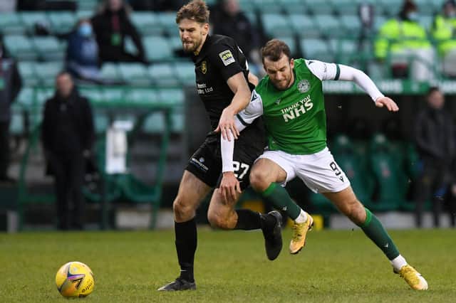 Livingston's Jon Guthrie (L) and Christian Doidge of Hibs in action.