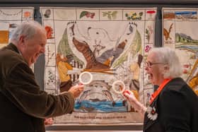 Chief stitcher Dorie Wilkie and author Alexander McCall Smith take a close look at a panel of the Great Tapestry of Scotland, which the writer's wife contributed to. The tapestry's new home opens in Galashiels on August 26. PIC: Phil Wilkinson.