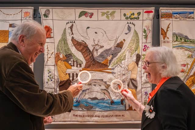 Chief stitcher Dorie Wilkie and author Alexander McCall Smith take a close look at a panel of the Great Tapestry of Scotland, which the writer's wife contributed to. The tapestry's new home opens in Galashiels on August 26. PIC: Phil Wilkinson.