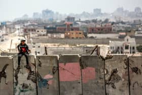 A boy sits atop a concrete barrier in al-Zahra in the central Gaza Strip. Picture: AFP via Getty Images