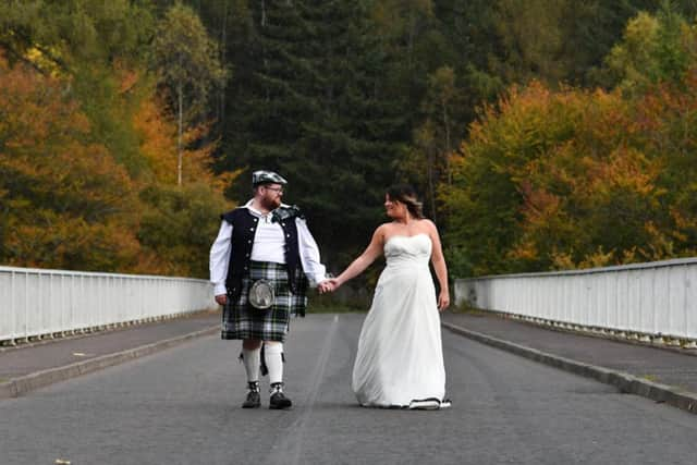 Newlyweds Magdalena Gordon and Iain Gordon walk across Gordon Bridge at Linn of Tummel near Pitlochry. Pictures: John Devlin.