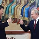 The murderous Vladimir Putin and Winnie the Pooh-lookalike Xi Jinping toast each other during a reception in March this year (Picture: Pavel Byrkin/Sputnik/AFP via Getty Images)