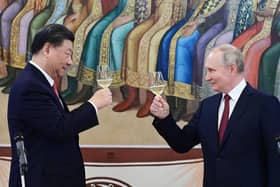 The murderous Vladimir Putin and Winnie the Pooh-lookalike Xi Jinping toast each other during a reception in March this year (Picture: Pavel Byrkin/Sputnik/AFP via Getty Images)