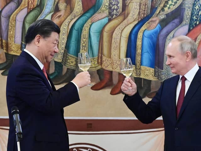 The murderous Vladimir Putin and Winnie the Pooh-lookalike Xi Jinping toast each other during a reception in March this year (Picture: Pavel Byrkin/Sputnik/AFP via Getty Images)
