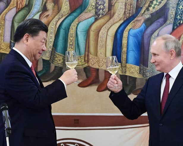 The murderous Vladimir Putin and Winnie the Pooh-lookalike Xi Jinping toast each other during a reception in March this year (Picture: Pavel Byrkin/Sputnik/AFP via Getty Images)