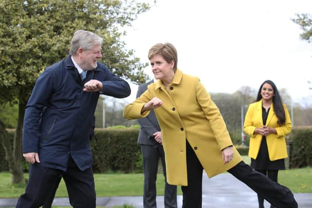 Nicola Sturgeon and Angus Robertson greet each other during a visit to Airdrie on Sunday (Picture: Andrew Milligan/pool/Getty Images)