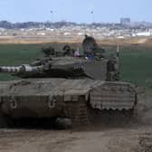 An Israeli Defense Forces tank drives away from the Gaza Strip, as seen from southern Israel. Picture: AP Photo/Tsafrir Abayov