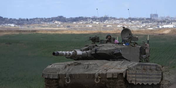 An Israeli Defense Forces tank drives away from the Gaza Strip, as seen from southern Israel. Picture: AP Photo/Tsafrir Abayov