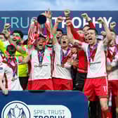 Airdrie captain Adam Frizzell lifts the SPFL Trust Trophy after the 2-1 victory over TNS at the Falkirk Stadium. (Photo by Craig Foy / SNS Group)