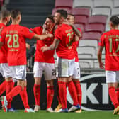 Benfica celebrate after scoring against Belgian club Standard Liege  (Photo by VIRGINIE LEFOUR/BELGA MAG/AFP via Getty Images)
