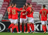 Benfica celebrate after scoring against Belgian club Standard Liege  (Photo by VIRGINIE LEFOUR/BELGA MAG/AFP via Getty Images)