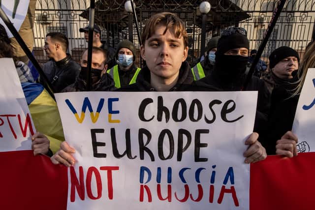 People protest outside the Russian Embassy in Kyiv, Ukraine, shortly before Vladimir Putin ordered his forces to invade (Picture: Chris McGrath/Getty Images)