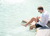 A man paddles in the fountain in Trafalgar Square, central London, as Britons are set to experience the hottest UK day on record as temperatures are predicted to hit 40C. Picture date: Tuesday July 19, 2022.