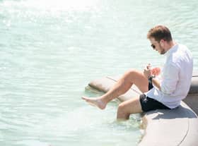 A man paddles in the fountain in Trafalgar Square, central London, as Britons are set to experience the hottest UK day on record as temperatures are predicted to hit 40C. Picture date: Tuesday July 19, 2022.