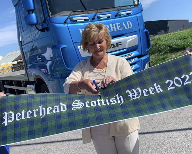 Scottish Week president, Elaine Cay, officially cuts the ribbon to open the gala week.