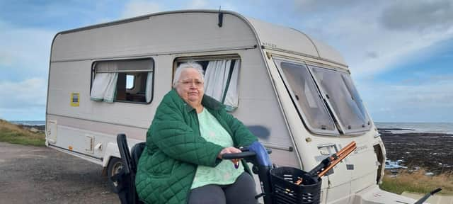 Joann Beattie next to the abandoned caravan in Johnshaven