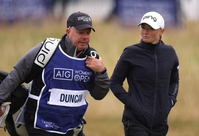 Dean Robertson walks with Louise Duncan during the AIG Women's Open at Muirfield. Picuture: Charlie Crowhurst/Getty Images.