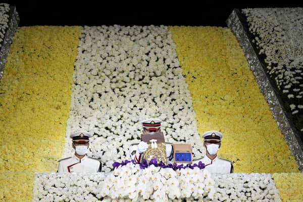 Honour guards carry the urn containing the ashes of Japan's former prime minister Shinzo Abe from the altar at the end of his state funeral in the Nippon Budokan in Tokyo on September 27, 2022. FRANCK ROBICHON/POOL/AFP via Getty Images