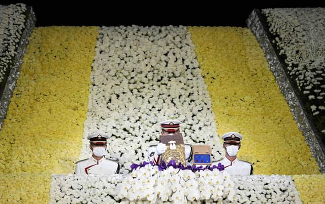Honour guards carry the urn containing the ashes of Japan's former prime minister Shinzo Abe from the altar at the end of his state funeral in the Nippon Budokan in Tokyo on September 27, 2022. FRANCK ROBICHON/POOL/AFP via Getty Images